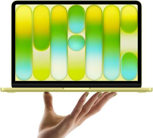 MacBook Neo w kolorze cytrusowożółtym, leżący na palcach otwartej dłoni, na ekranie widać kolorowy abstrakcyjny wzór