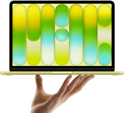MacBook Neo w kolorze cytrusowożółtym, leżący na palcach otwartej dłoni, na ekranie widać kolorowy abstrakcyjny wzór